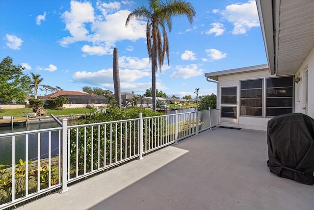 balcony featuring a grill and a water view