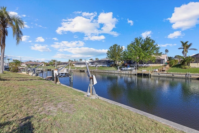 dock area featuring a lawn and a water view