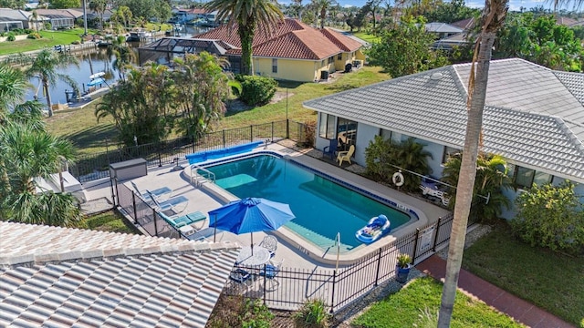 view of pool with a water view and a patio