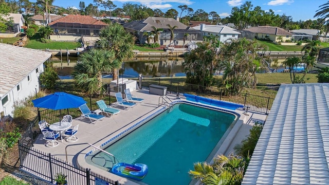 view of pool with a water view and a patio