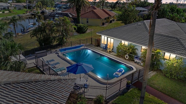 pool at dusk with a patio