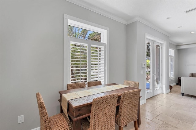 dining space with ornamental molding