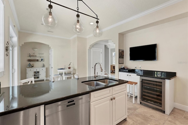 kitchen with dishwasher, sink, decorative light fixtures, white cabinetry, and beverage cooler