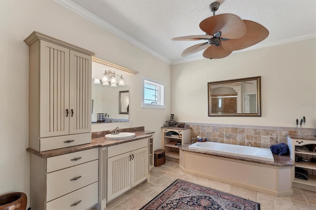 bathroom with ceiling fan, crown molding, a textured ceiling, and vanity