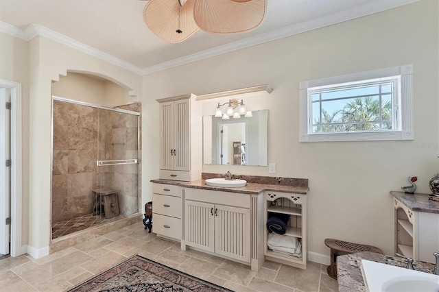 bathroom with vanity, ceiling fan, an enclosed shower, and ornamental molding