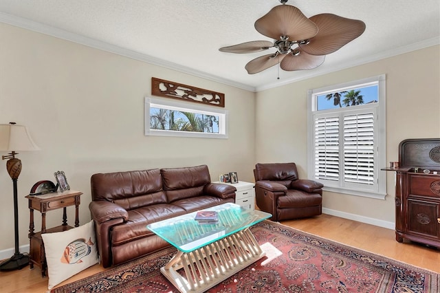 living room with ceiling fan, light hardwood / wood-style floors, and crown molding