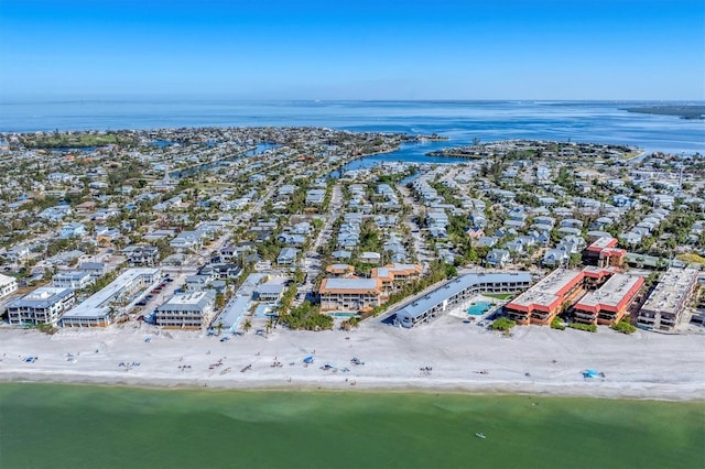 birds eye view of property with a water view and a beach view