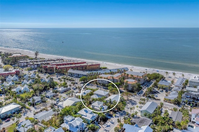 bird's eye view featuring a water view and a beach view