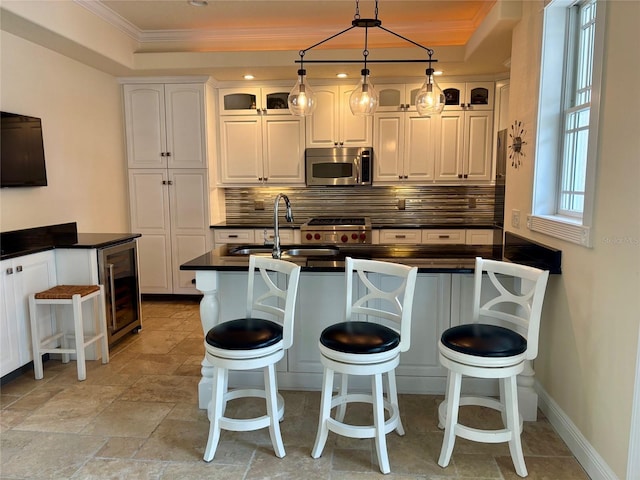 6405 Gulf Dr, Holmes Beach, FL 34217 - kitchen with tasteful backsplash, dark countertops, crown molding, stainless steel microwave, and beverage cooler