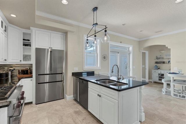 6405 Gulf Dr, Holmes Beach, FL 34217 - kitchen with arched walkways, a peninsula, appliances with stainless steel finishes, a sink, and dark countertops