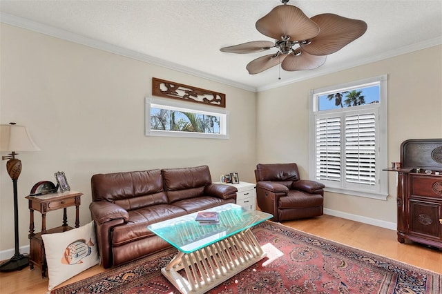 6405 Gulf Dr, Holmes Beach, FL 34217 - living area featuring crown molding, light wood-style flooring, ceiling fan, and a healthy amount of sunlight