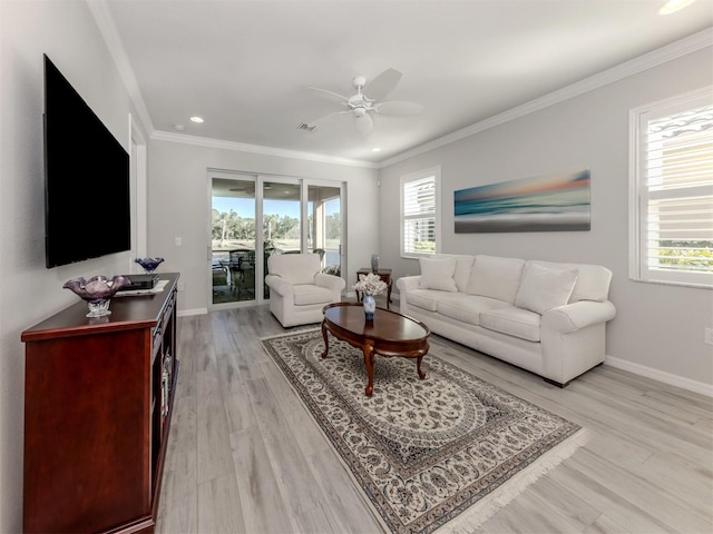 living room featuring plenty of natural light, ceiling fan, light wood-type flooring, and ornamental molding