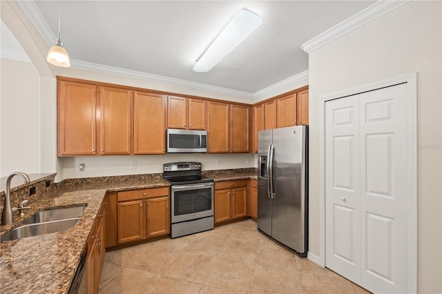 kitchen with pendant lighting, crown molding, sink, dark stone countertops, and stainless steel appliances