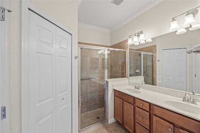 bathroom with tile patterned floors, vanity, an enclosed shower, and ornamental molding