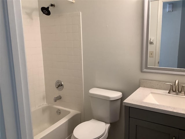 full bathroom with vanity, tiled shower / bath combo, and toilet