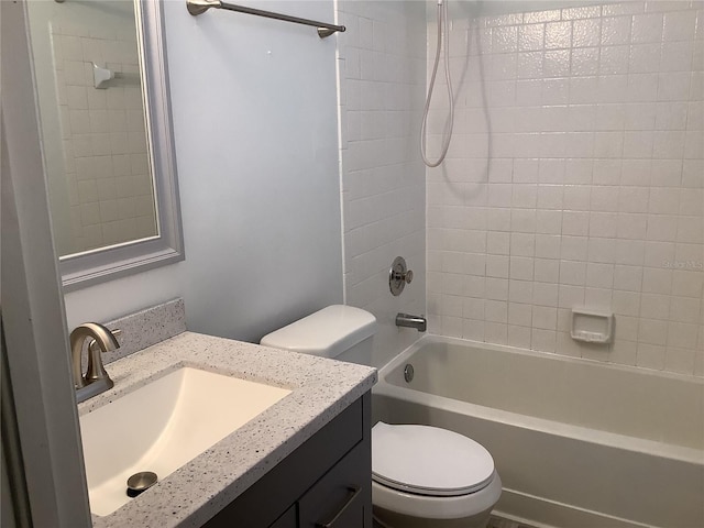 full bathroom with vanity, toilet, and tiled shower / bath combo