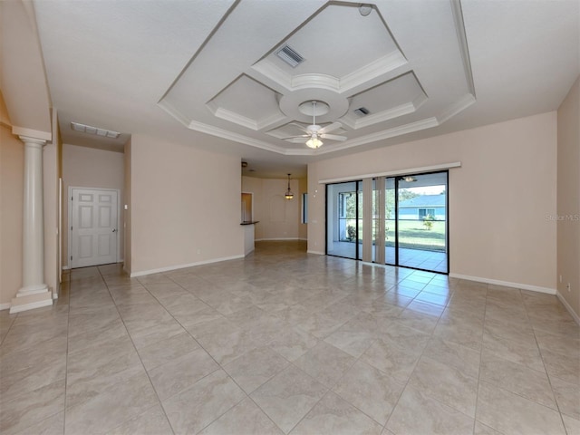 unfurnished room featuring a raised ceiling, ornate columns, ceiling fan, and ornamental molding