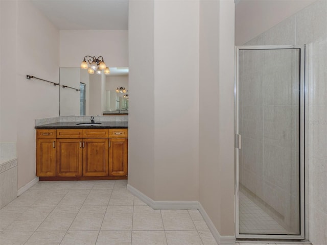 bathroom with tile patterned flooring, vanity, and independent shower and bath