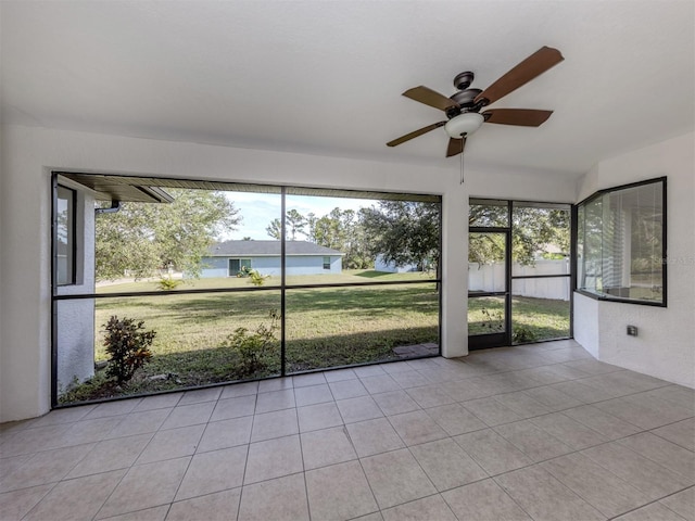 unfurnished sunroom featuring ceiling fan