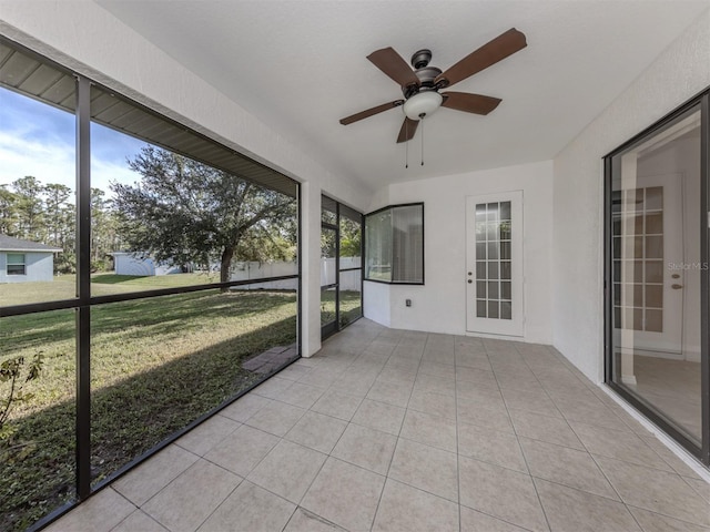 unfurnished sunroom featuring ceiling fan