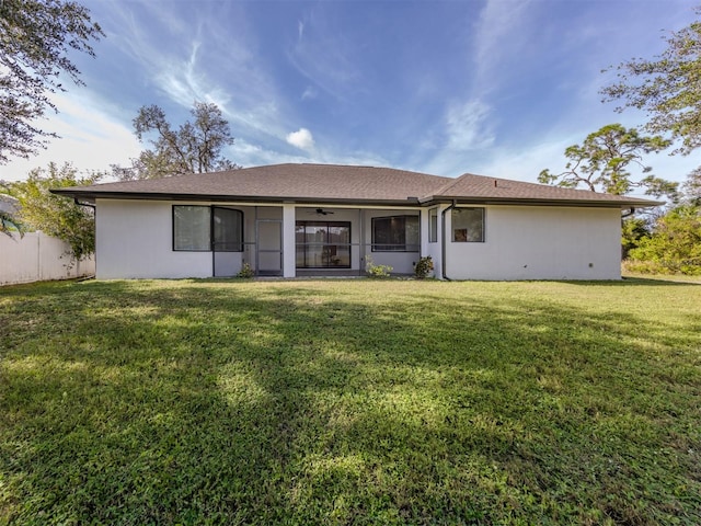 back of property featuring a yard