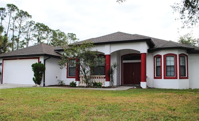 view of front facade with covered porch, a garage, and a front lawn