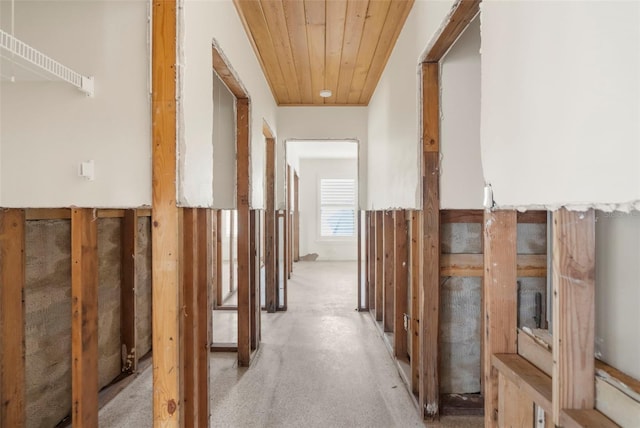 hallway with wooden ceiling and light carpet