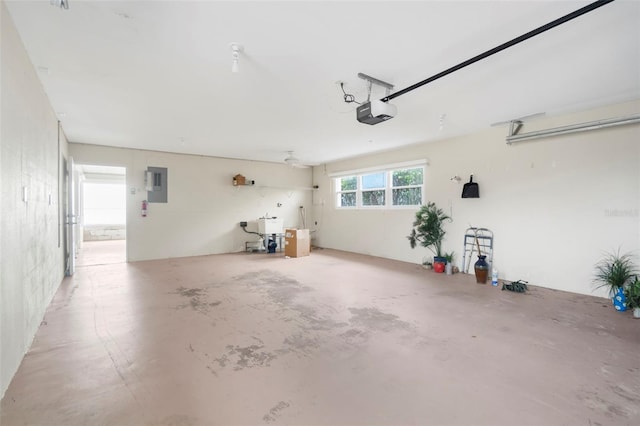 garage with a garage door opener and electric panel