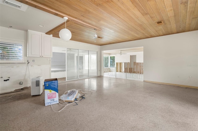 interior space featuring ceiling fan and wooden ceiling