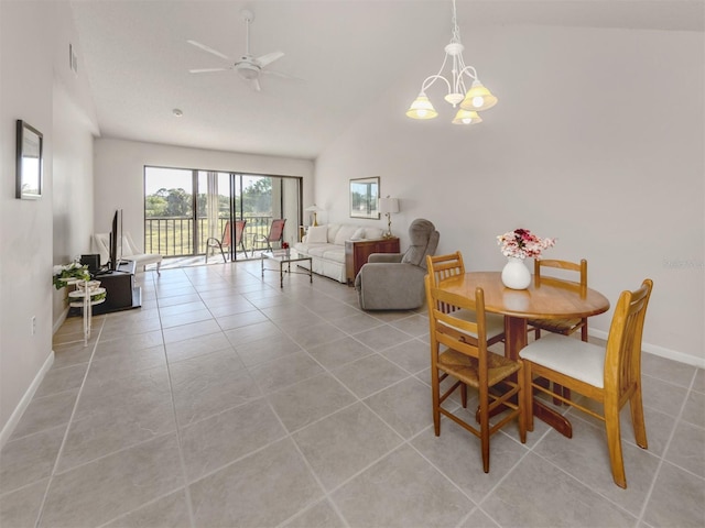 dining room featuring ceiling fan with notable chandelier, lofted ceiling, and light tile patterned floors