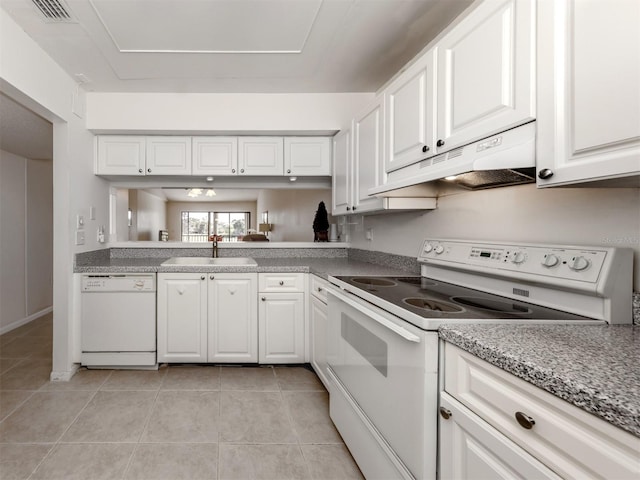 kitchen with white cabinetry, sink, light tile patterned floors, and white appliances