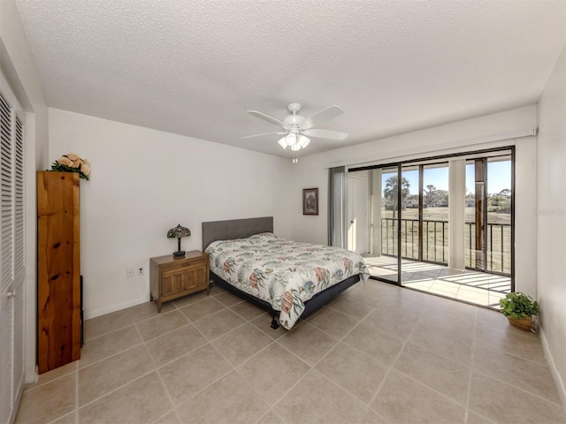 bedroom featuring access to exterior, ceiling fan, a textured ceiling, a closet, and light tile patterned floors