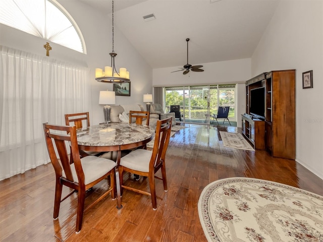 dining space featuring ceiling fan, high vaulted ceiling, and hardwood / wood-style flooring