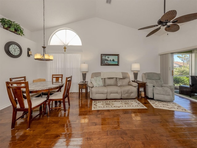 living room with ceiling fan, dark hardwood / wood-style flooring, and high vaulted ceiling