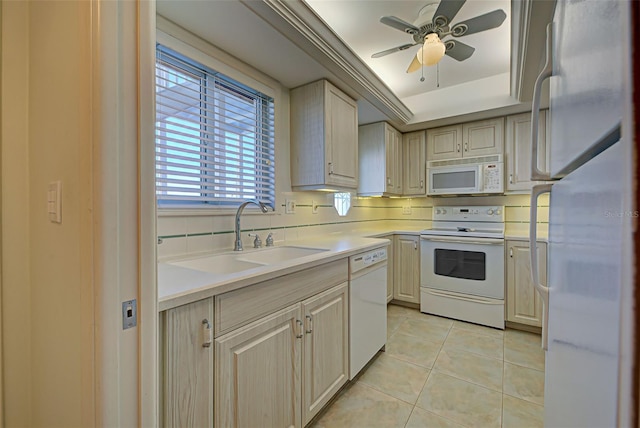 kitchen featuring ceiling fan, sink, white appliances, decorative backsplash, and light tile patterned flooring