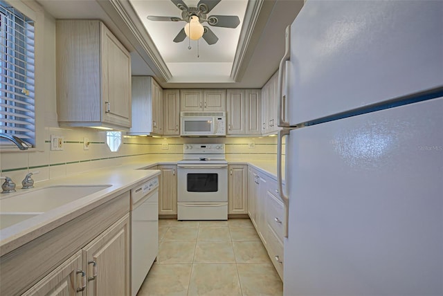 kitchen with white appliances, sink, ceiling fan, light tile patterned floors, and light brown cabinetry