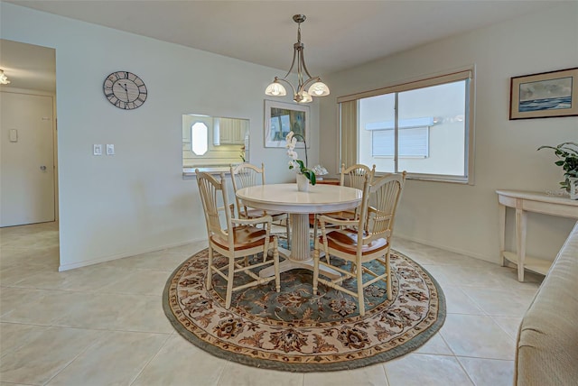 dining area with light tile patterned floors and a chandelier