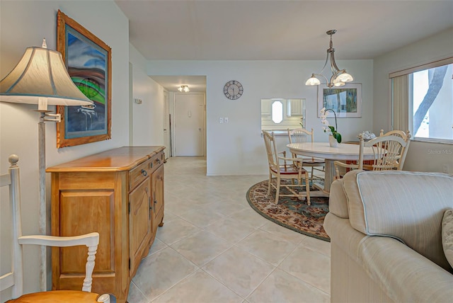 tiled dining space featuring a notable chandelier