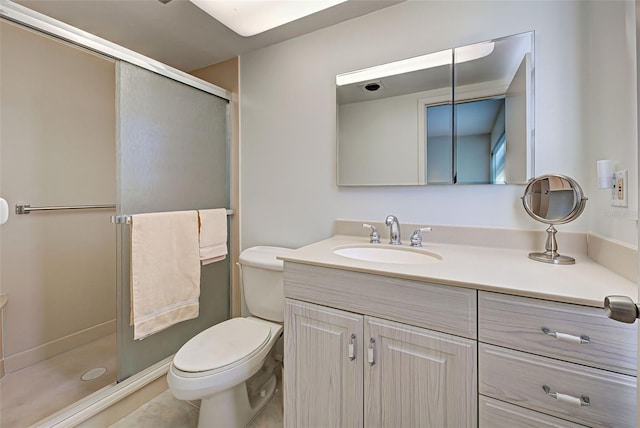 bathroom with an enclosed shower, vanity, toilet, and tile patterned flooring