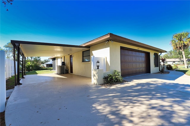 view of front of home with a garage and a carport