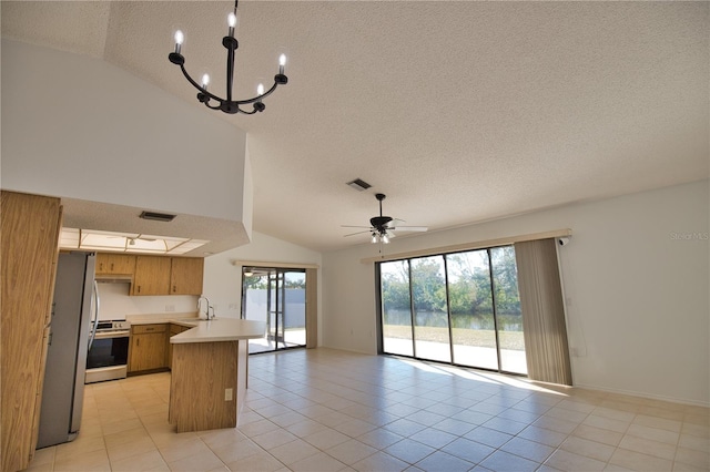 kitchen featuring kitchen peninsula, a textured ceiling, ceiling fan with notable chandelier, stainless steel appliances, and sink