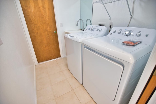 washroom featuring light tile patterned floors and washing machine and clothes dryer