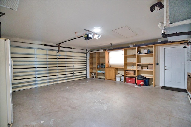 garage with a garage door opener and white refrigerator