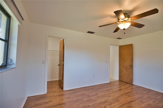 spare room featuring hardwood / wood-style flooring and ceiling fan