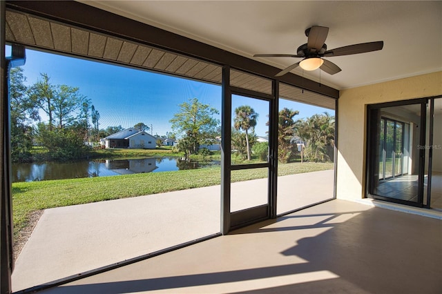 sunroom with a water view and ceiling fan