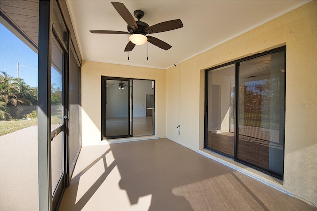 unfurnished sunroom with ceiling fan