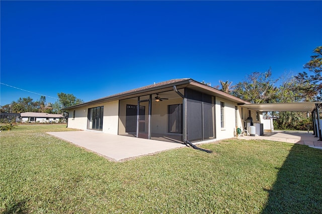 back of property featuring a lawn, central AC unit, and a patio