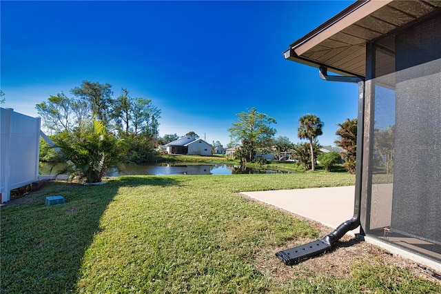 view of yard with a water view and a patio