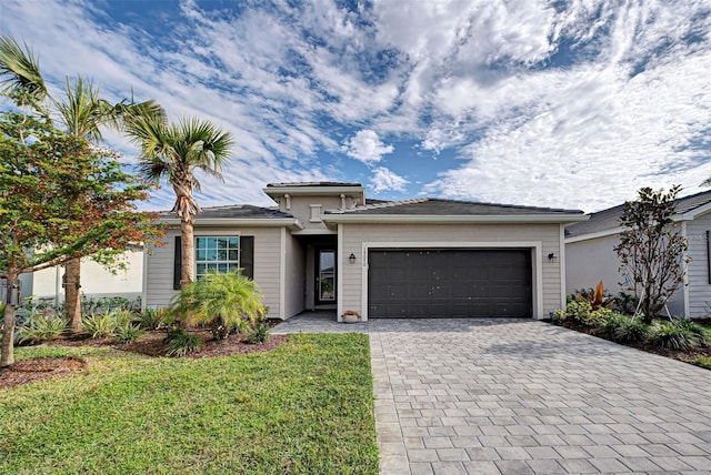 view of front of house with a garage and a front yard