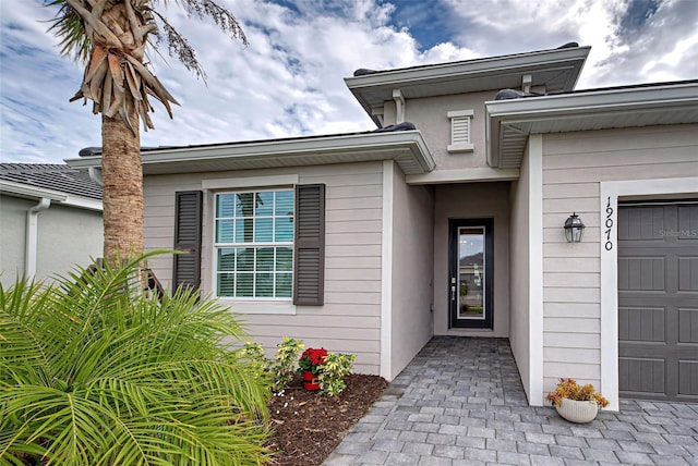 doorway to property with a garage